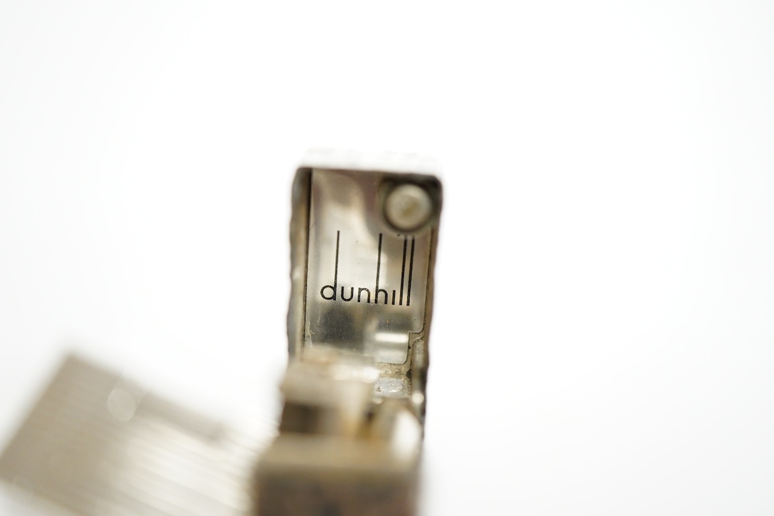 Three assorted plated Dunhill lighters and a gilt example, largest 6.5cm high